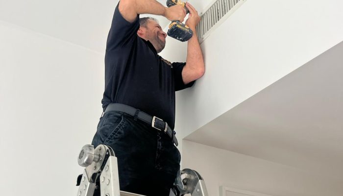person-fixing-air-duct